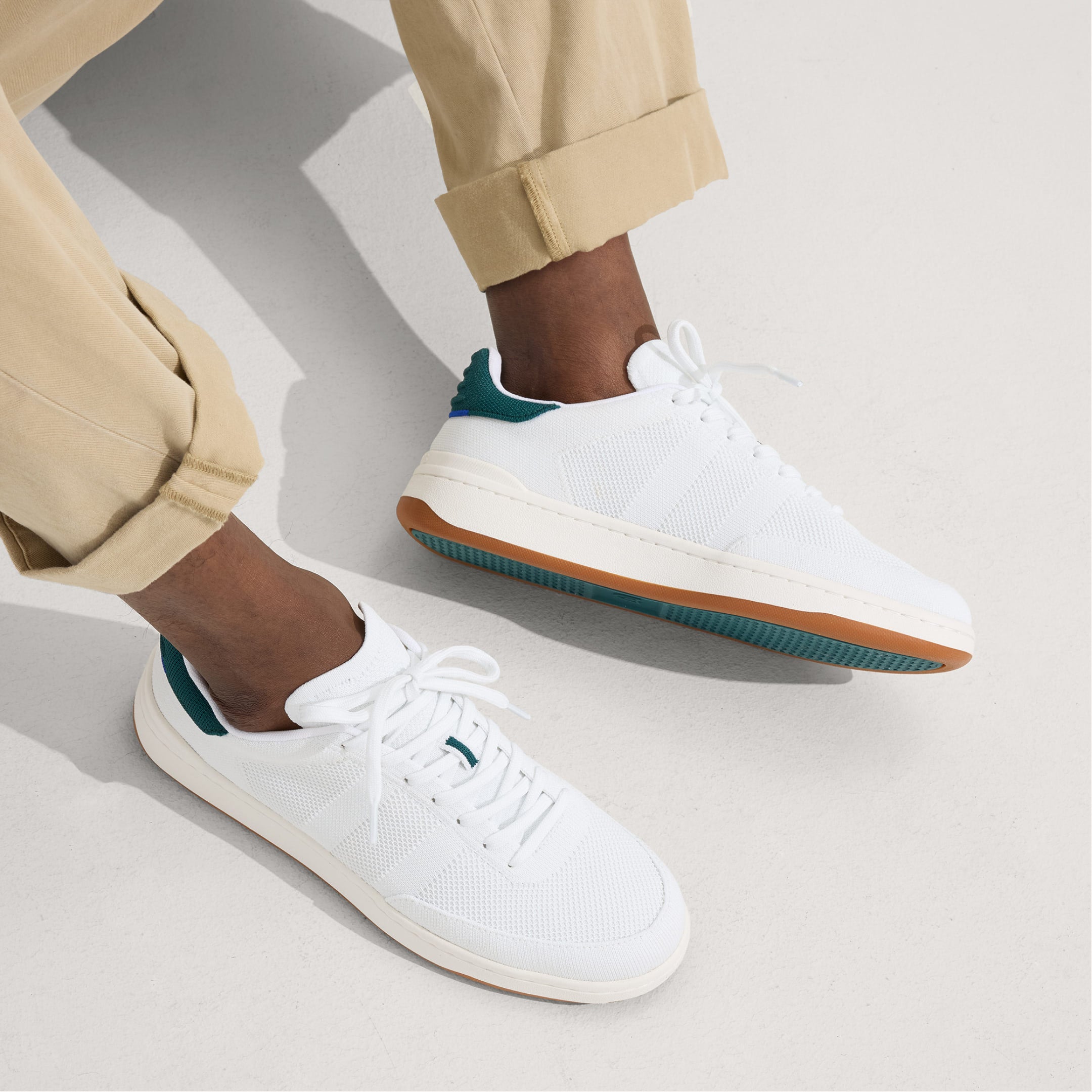 A model wearing The Men's Court Sneaker.