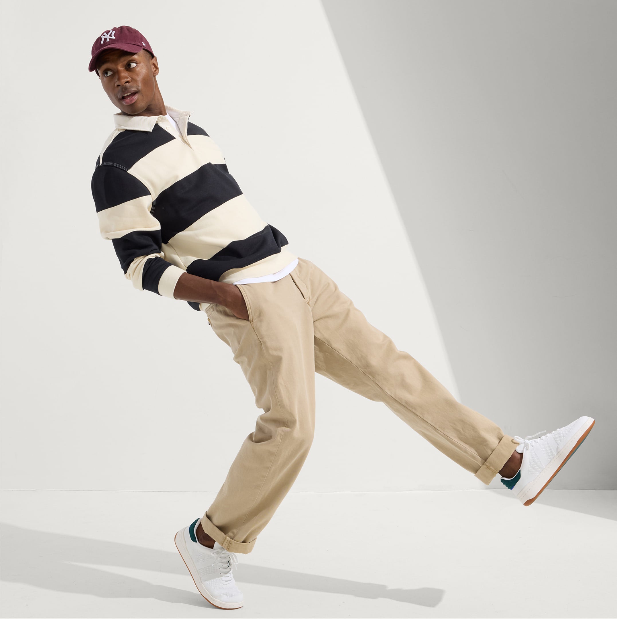 A model wearing The Men's Court Sneaker.