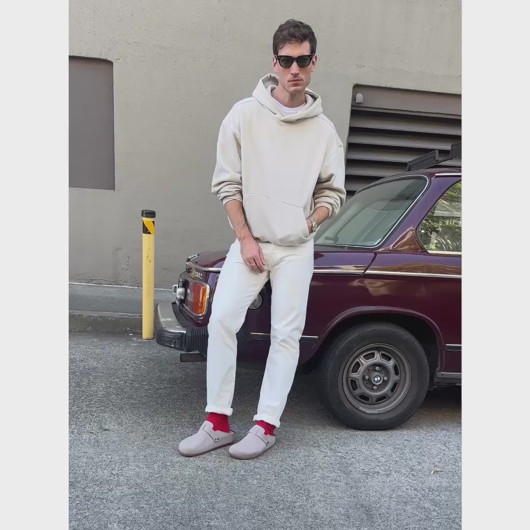 Model wearing The Men's Clog in Dove and showing different angles of the shoe.