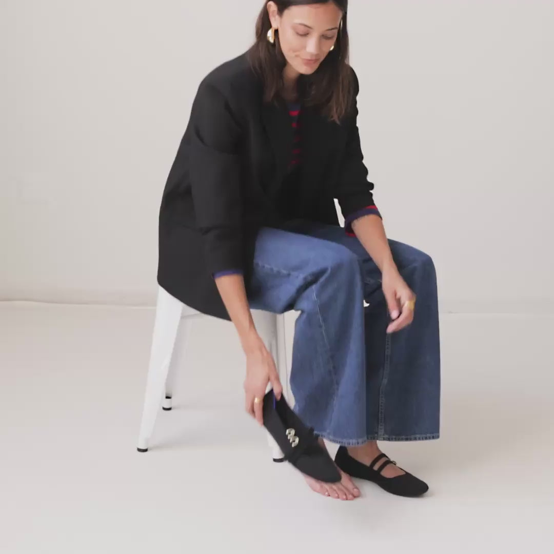 Model walking in The Double Buckle Mary Jane in Black and showing different angles of the shoes. 
