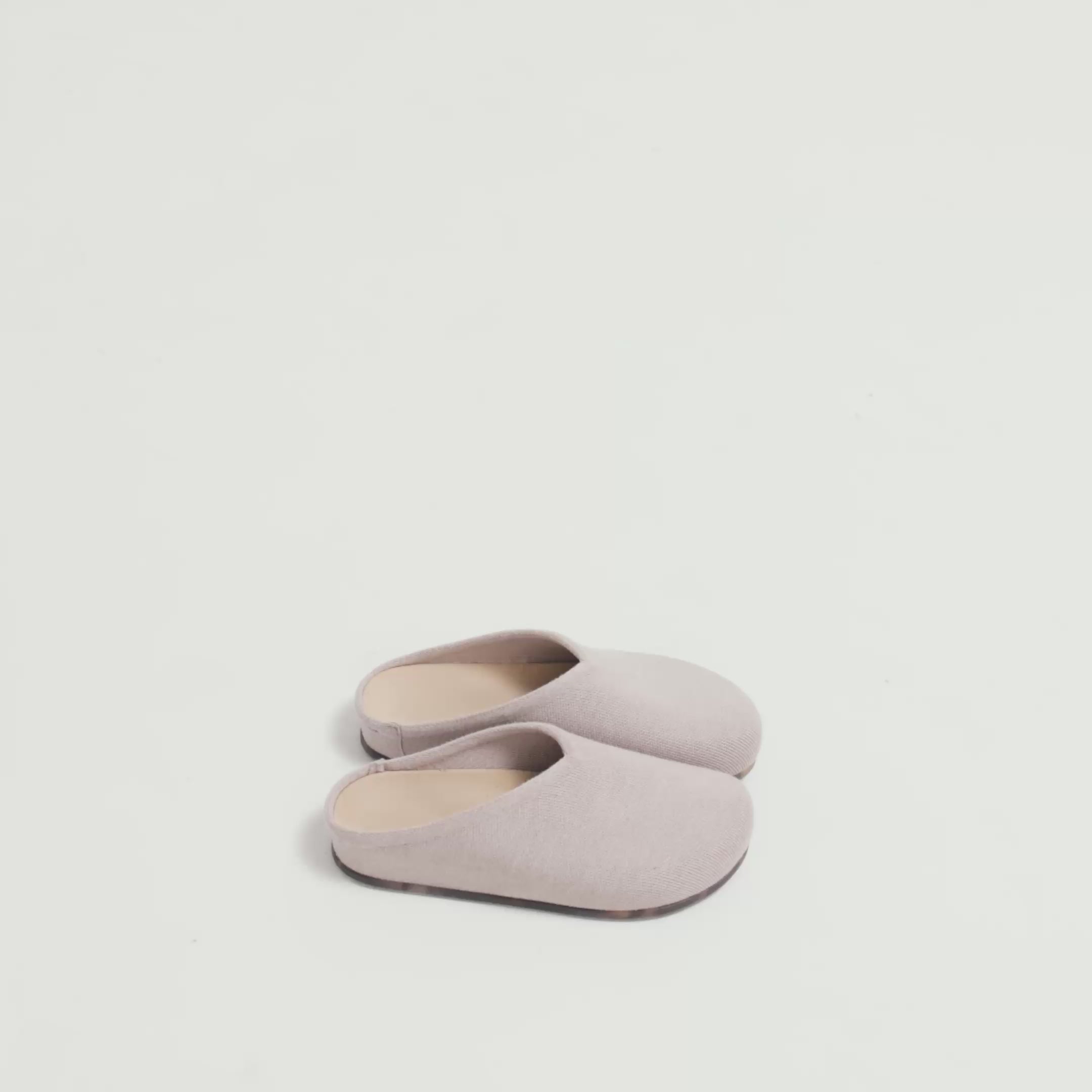 Model walking in The Casual Clog in Dove and showing different angles of the shoes. 